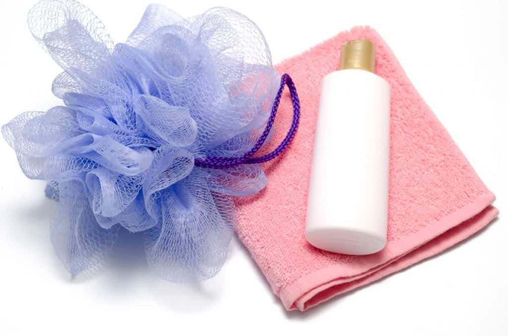 Body wash vs. bar soap, bath puff with liquid soap and towel