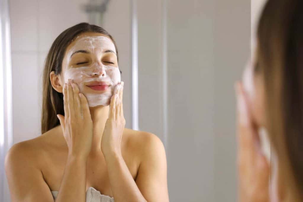 Natural soap for acne, woman washing face